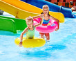 Child on water slide at aquapark.