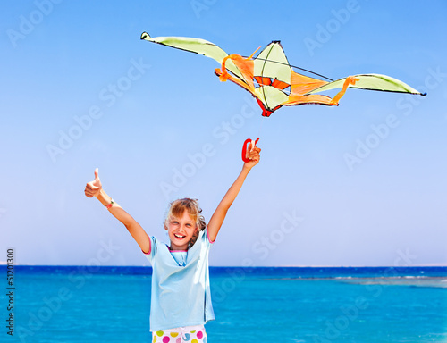 Photo: Kid flying kite outdoor. Kid flying kite outdoor.