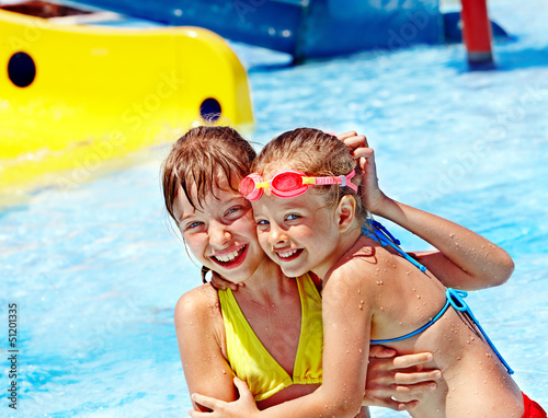 Photo: Children on water slide at aquapark. Children on water slide at aquapark.