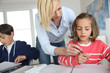 Photo: Children sitting in classroom with teacher Children sitting in classroom with teacher