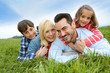 Family of four relaxing in countryside