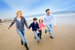 Foto: Family running on the beach Family running on the beach