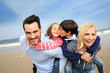 Portrait of cheerful family at the beach
