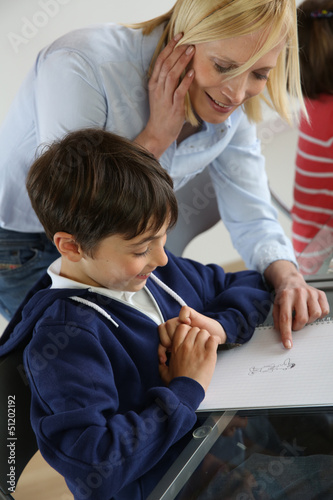 Photo: Teacher with kid in classroom Teacher with kid in classroom
