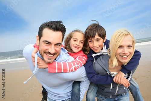 Photo: Portrait of cheerful family at the beach Portrait of cheerful family at the beach