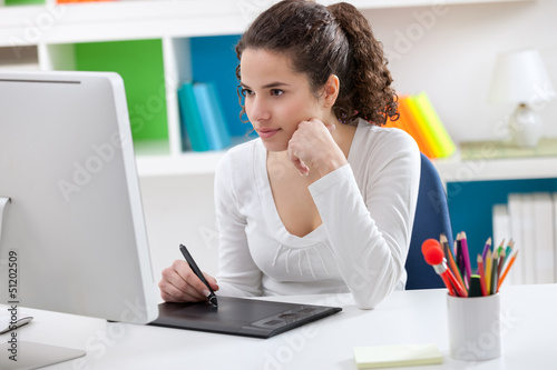 Photo: Young graphic designer working Young graphic designer working