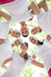 Six women standing with their heads in circle