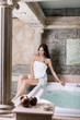 Pretty young woman relaxing in the hot tub