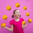 Photo: Grapefruit - a young girl juggling grapefruits - diet concept Grapefruit - a young girl juggling grapefruits - diet concept