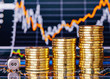 Uptrend stacks coins, dices cube with the word GO on the financi