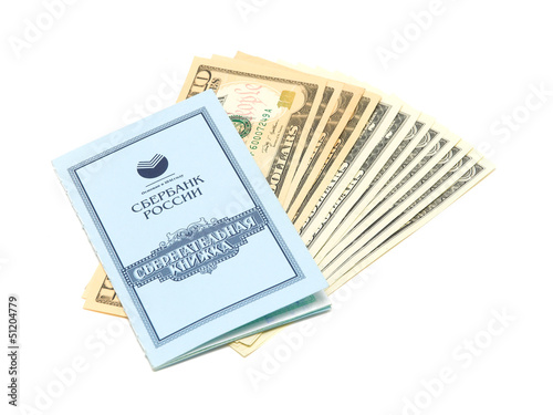 Photo: savings book and U.S. dollars isolated on white background savings book and U.S. dollars isolated on white background