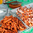 Foto: Traditional Thai food at market. Roasted spicy pork Traditional Thai food at market. Roasted spicy pork