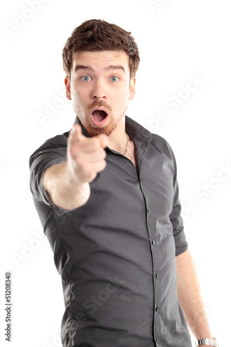 Photo: Portrait of smiling handsome man pointing at you over white Portrait of smiling handsome man pointing at you over white