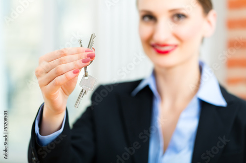 Photo: Young realtor is with keys in an apartment Young realtor is with keys in an apartment