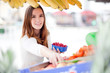Young woman picking fruit at the market