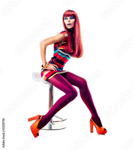 Photo: Fashion Dressed Sexy Girl Sitting on Chair. Full length Portrait Fashion Dressed Sexy Girl Sitting on Chair. Full length Portrait