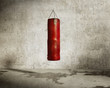 Grungy martial arts training room, red boxing bag