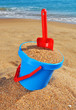 Photo: Baby bucket with sand and a shovel on the beach Baby bucket with sand and a shovel on the beach