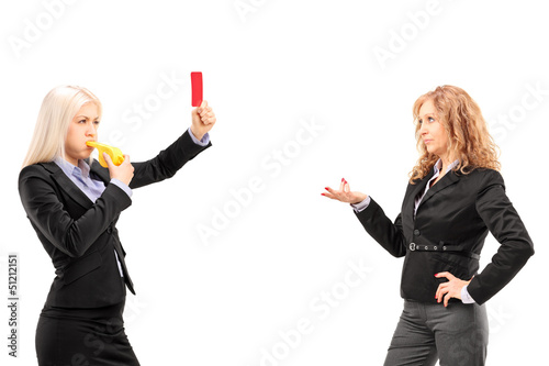 Photo: Businesswoman showing a red card to another businesswoman Businesswoman showing a red card to another businesswoman