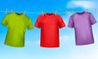 Set of colored t-shirts hanging on a clothesline.