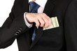 Business man hiding money in pocket isolated on white