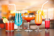 Several glasses of different drinks on bright background