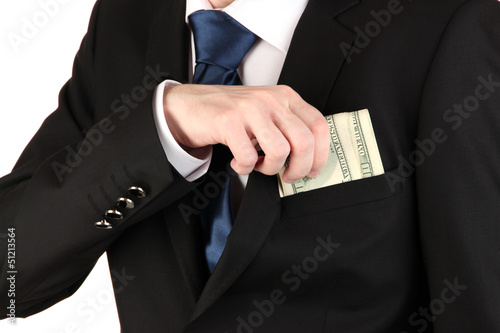 Photo: Business man hiding money in pocket isolated on white Business man hiding money in pocket isolated on white
