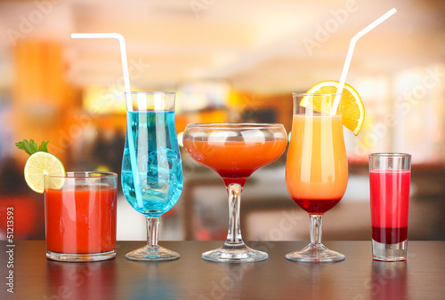 Photo: Several glasses of different drinks on bright background Several glasses of different drinks on bright background