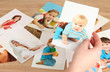 Photos in hands on wooden table