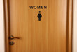 Toilet sign on wooden door