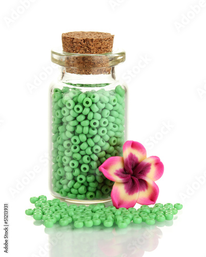 Photo: Little bottle full with colorful beads isolated on white Little bottle full with colorful beads isolated on white