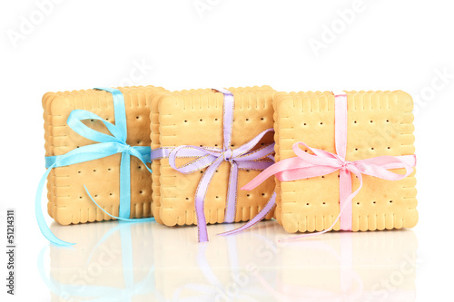 Photo: Sweet cookies tied with colorful ribbons isolated on white Sweet cookies tied with colorful ribbons isolated on white