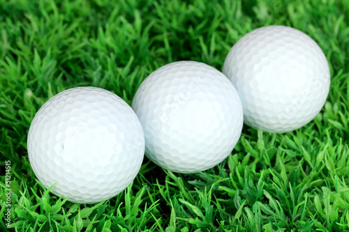 Photo: Golf balls on grass close up Golf balls on grass close up