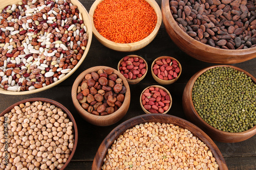 Photo: Different kinds of beans in bowls on table close-up Different kinds of beans in bowls on table close-up