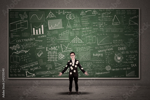 Photo: Busy businessman on written chalkboard Busy businessman on written chalkboard