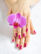 Beautiful hands with manicure and purple orchid flower