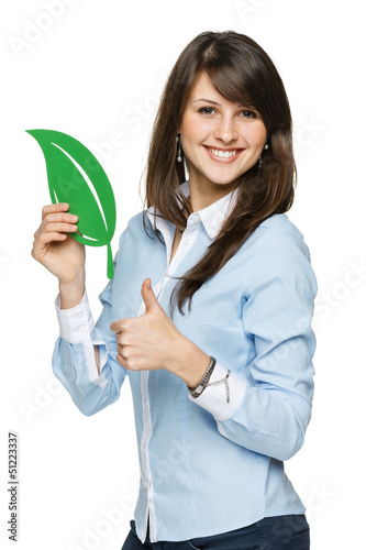 Photo: Woman holding eco leaf and showing thumb up sign Woman holding eco leaf and showing thumb up sign