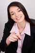 Young smiling business woman pointing finger at viewer