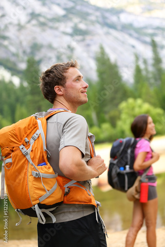 Photo: Hiking people - man hiker looking in nature Hiking people - man hiker looking in nature