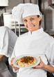 Female Chef Showing Pasta Dish
