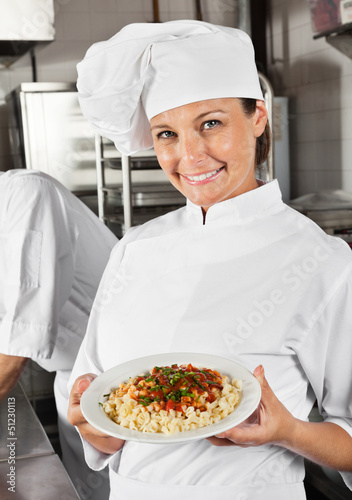 Photo: Female Chef Showing Pasta Dish Female Chef Showing Pasta Dish