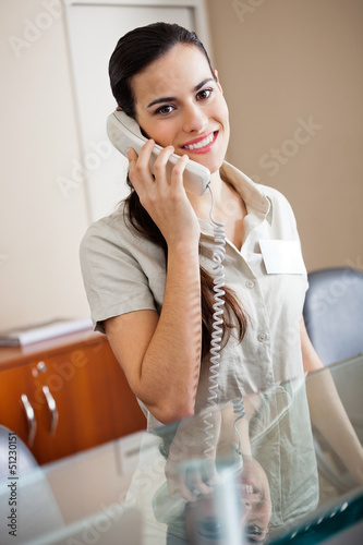 Photo: Female Receptionist Attending Call Female Receptionist Attending Call