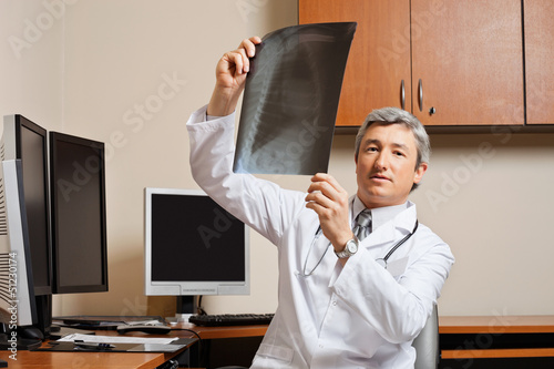 Photo: Radiologist Holding Shoulder X-ray Radiologist Holding Shoulder X-ray