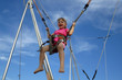 Girl bungee jumping on a trampoline