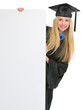 Woman in graduation gown looking out from blank billboard