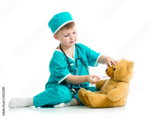 Photo: boy kid playing doctor with plush toy boy kid playing doctor with plush toy