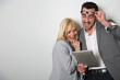Trendy couple websurfing on digital tablet