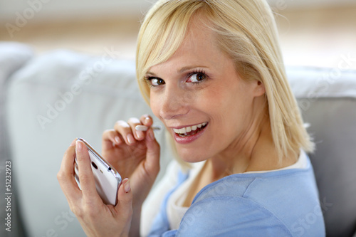Photo: Beautiful smiling woman using smartphone Beautiful smiling woman using smartphone