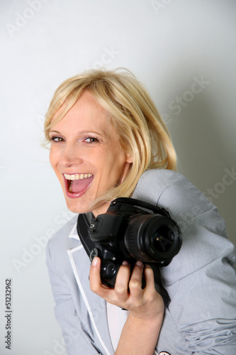 Photo: Cheerful woman photographer holding camera Cheerful woman photographer holding camera