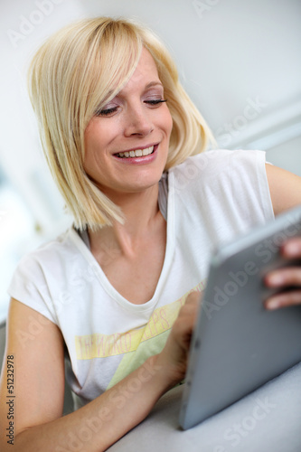 Photo: Beautiful smiling woman using digital tablet Beautiful smiling woman using digital tablet